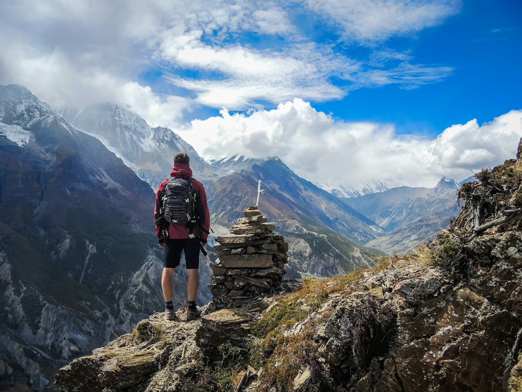 A traveller looking out over a mountain valley